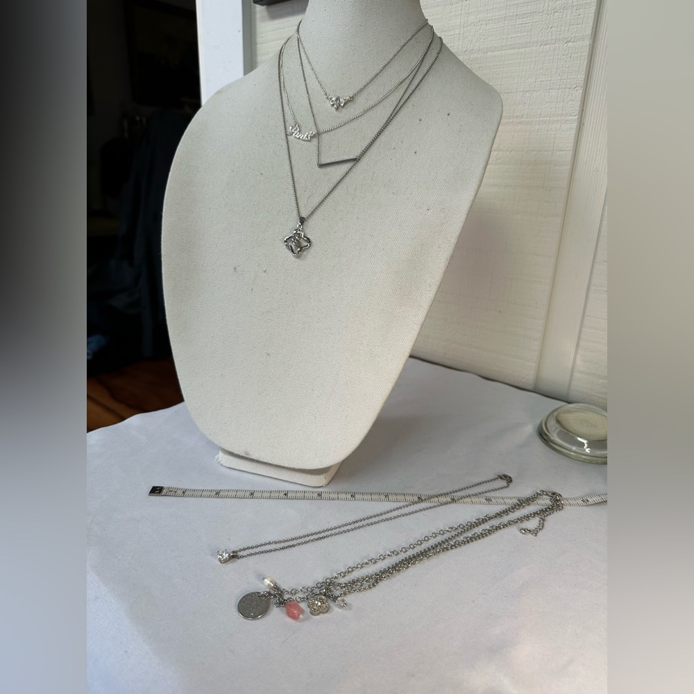 Six dainty feminine silvertone necklaces